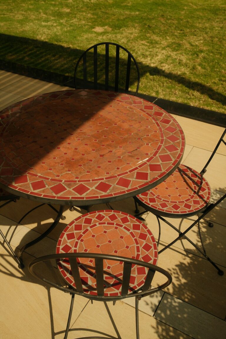 A residential outdoor patio with a stamped concrete surface in a natural stone pattern.